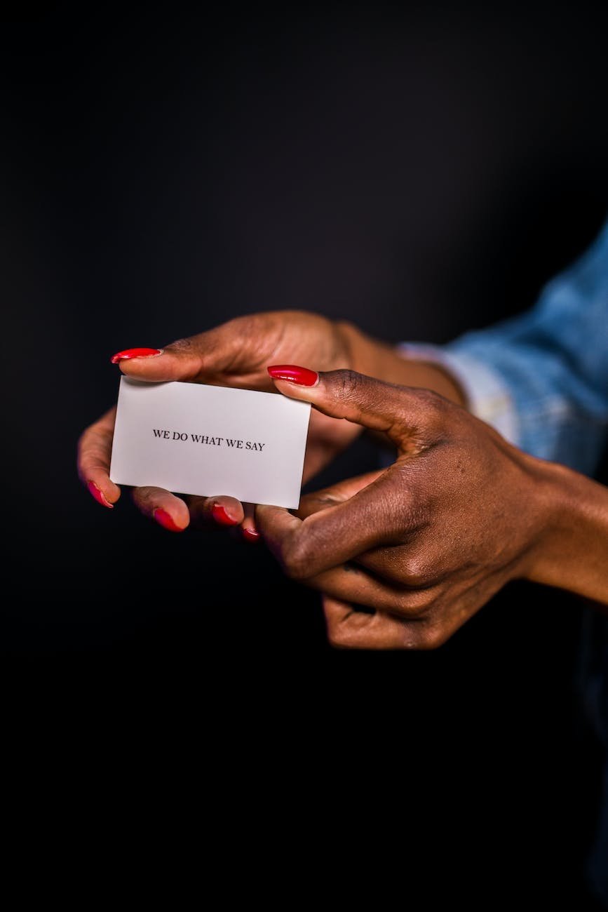 close up of woman holding a business card